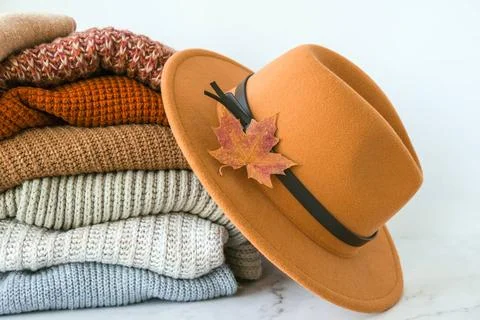 Stack of cozy knitted warm sweater with Autumn fall maple leaf and beige s... Stock Photos