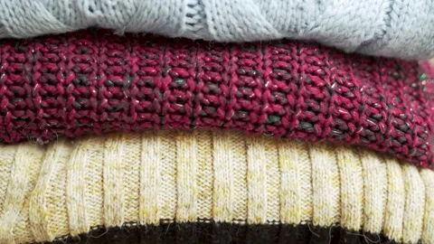 Stack of Cozy Soft Knitted Sweaters, Warm Plaids, Winter Clothes, Closeup. Backg Stock Footage 220709832