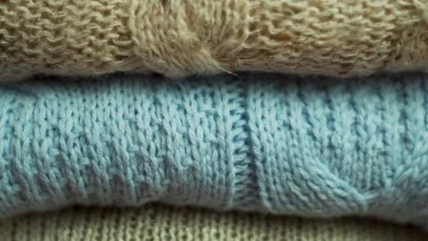 Stack of Cozy Warm Woolen Knitted Sweaters, Plaids, Bedspreads,Close-up.  Backgr Stock Footage 220065045