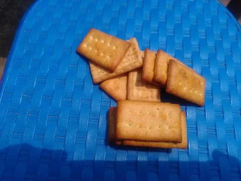 Stack of crackers on blue surface. 스톡 사진