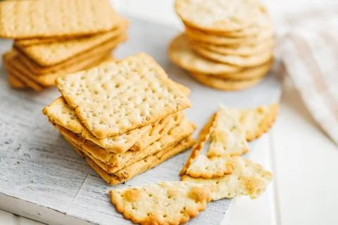 A stack of crackers neatly arranged on a tabletop. Stock Photos