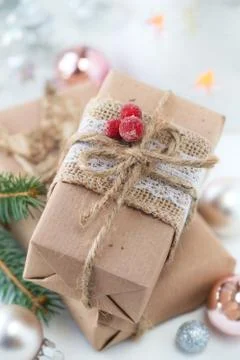 Stack of craft paper wrapped Christmas gifts with festive decorations Stock Photos