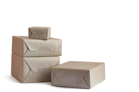 Stack of craft wrapped boxes for deliveryon white background Stock Photos