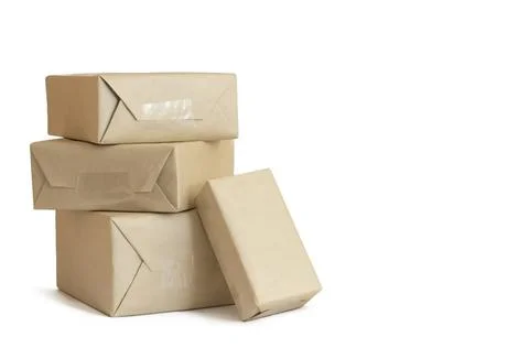 Stack of craft wrapped boxes for deliveryon white background Stock Photos
