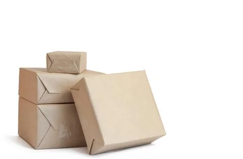 Stack of craft wrapped boxes for deliveryon white background Stock Photos