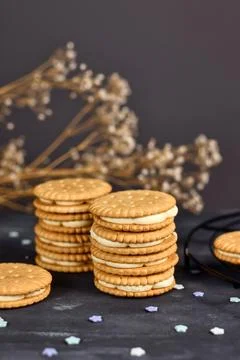 Stack of cream filled sandwich double cookies on dark background 写真素材