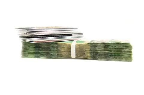 Stack of credit cards on top stack of green polymer bills isolated on white b 스톡 사진