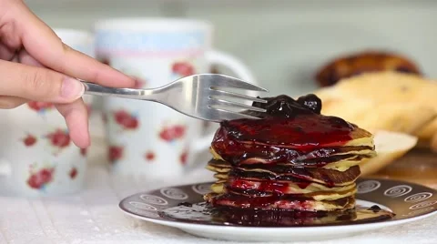 Stack of Crepes (pancakes), one crepe rolled on a fork, with jam. Fitness low Stock Footage 68004208