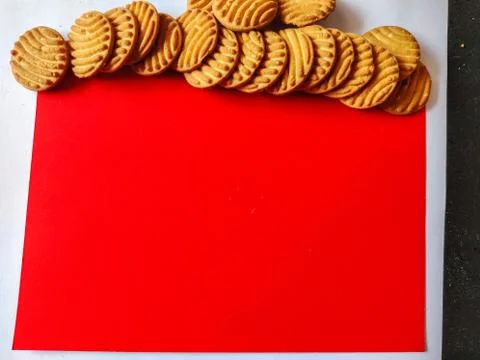 Stack of crispy cookies or biscuits in top. Copy space. Red background. Stock Photos