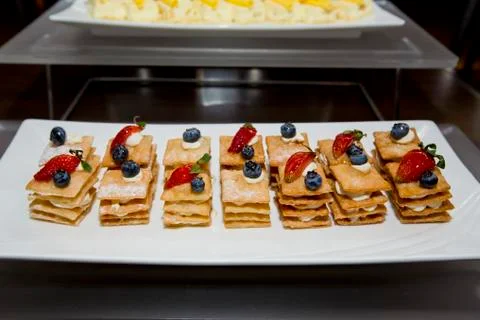 Stack of crispy pancake with banana slice topping of strawberry, blueberry an Stock Photos