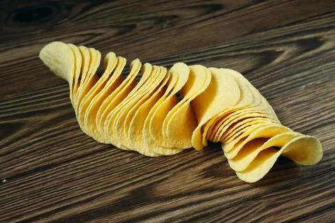 Stack of Crispy Potato Chips on Wooden Table Fotos Stock