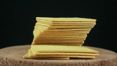 Stack of crispy salted crackers on black background. Rotating display 스톡 동영상 293776936