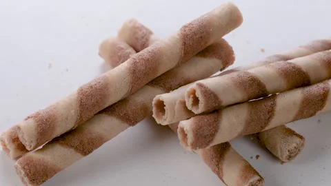 A stack of crispy wafer rolls with hazelnut cream in a close-up view. Video stock 296533266