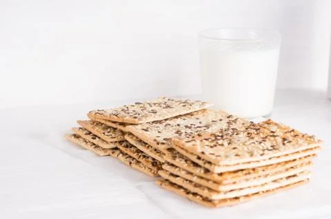 Stack of crispy wheat cakes with sesame , flax and sunflower seeds with glass Stock Photos
