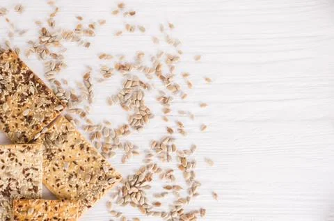 Stack of crispy wheat cakes with sesame, flax and sunflower seeds on white wo Stock Photos