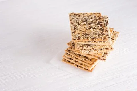 Stack of crispy wheat cakes with sesame, flax and sunflower seeds on on a nap Stock Photos