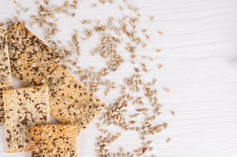 Stack of crispy wheat cakes with sesame, flax and sunflower seeds on white wo Stock Photos