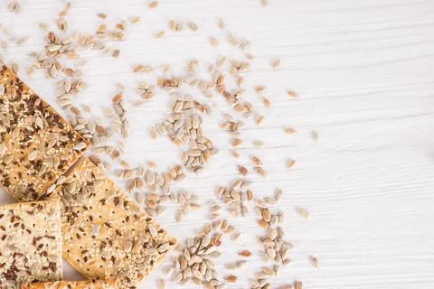 Stack of crispy wheat cakes with sesame, flax and sunflower seeds on white wo Stock Photos