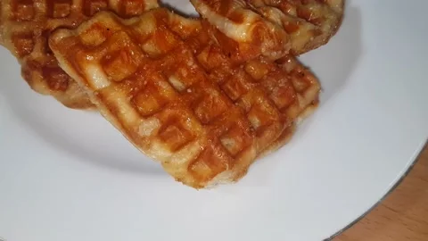 Stack of Croissant Waffle or Croffle served in white plate and wooden background Stock Footage 165210146