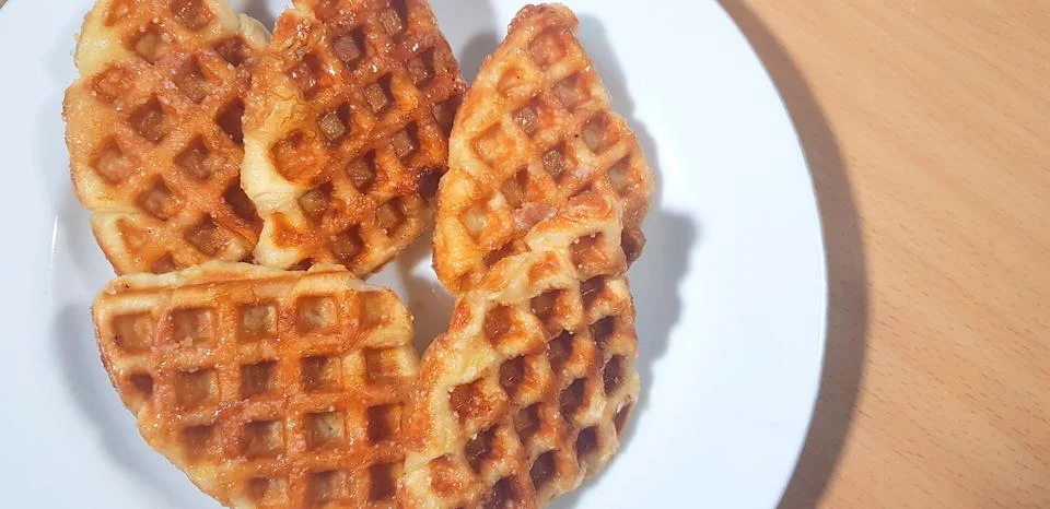 Stack of Croissant Waffle or Croffle served in white plate and wooden background Stock Photos