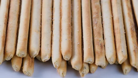 Stack of crunchy salted pretzel sticks. Slider shot. Food, nutrition, snacks Stock Footage 296535126