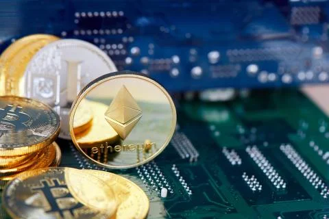 Stack of cryptocurrencies in a circle with ethereum on the top on motherboard Stock Photos