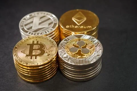 Stack of cryptocurrencies. Etherum, ripple, bitcoin. litecoin on dark leather. 스톡 사진