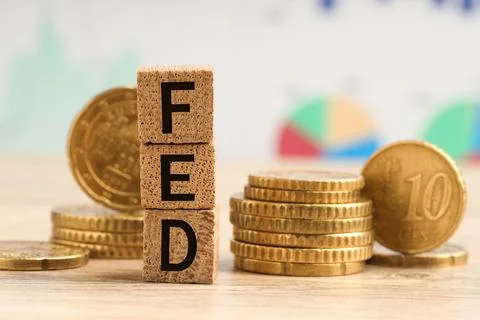 Stack of cubes with letters Fed (Federal Reserve System) and coins on woode.. Stockfoto's
