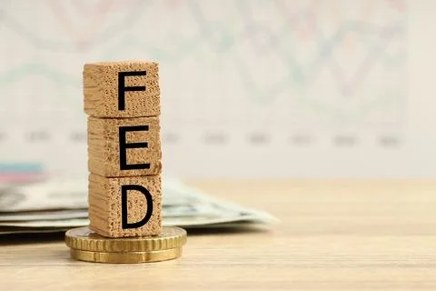 Stack of cubes with letters Fed (Federal Reserve System), dollar banknotes .. 写真素材