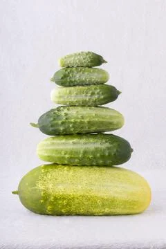A stack of cucumbers is arranged in a pyramid shape 스톡 사진
