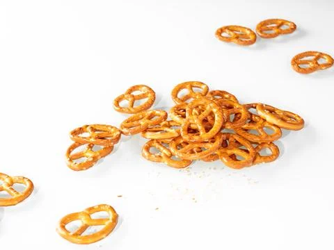 Stack of cumin pretzels on white background Foto stock