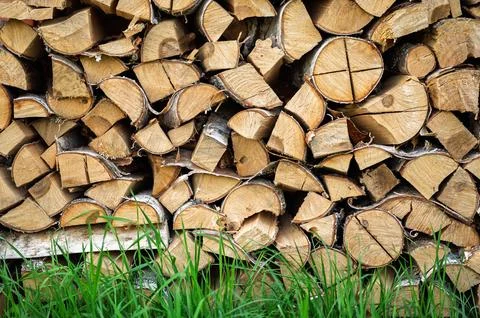 Stack of cut birch logs for fireplace, preparation for cold season in the cou Stock Photos