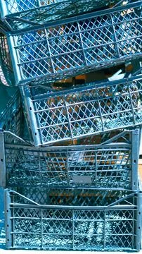 Stack of dark blue plastic crates for fruits and vegetables closeup Stock Photos
