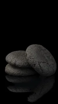 Stack of Dark Chocolate Cookies with Cracked Texture on Black Background Stock Photos