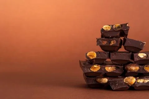 Stack of dark chocolate pieces with roasted almonds Stock Photos
