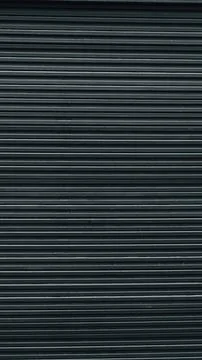 Stack of dark composite decking boards, focusing on the repetitive linear tex Stock Photos