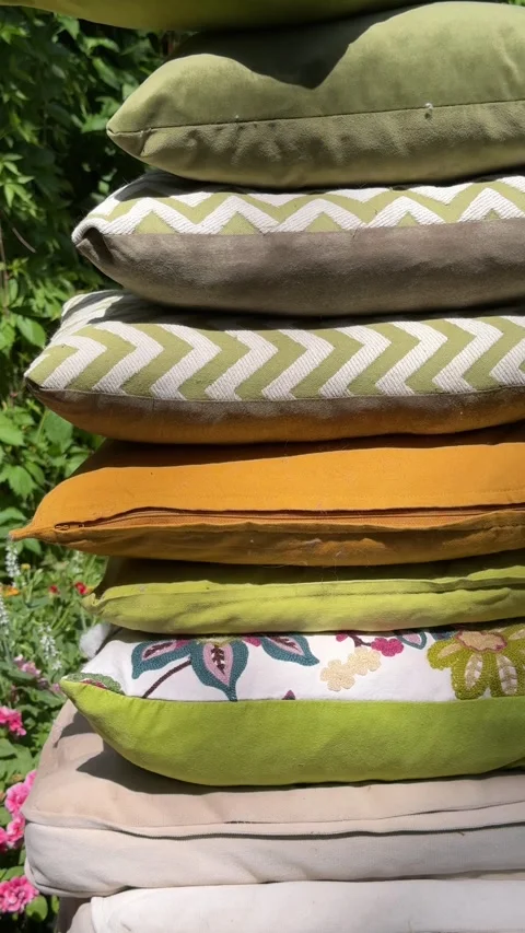 Stack of Decorative Outdoor Cushions on Garden Swing Under Green Pergola Video stock 336975724