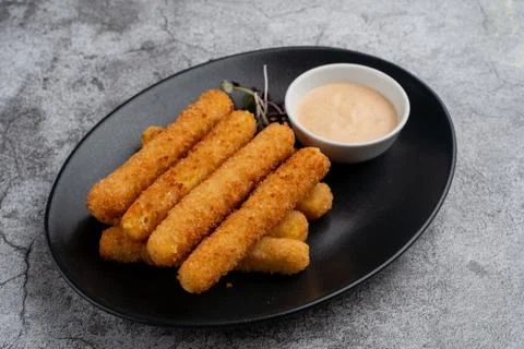 Stack of deep fried mozzarella cheese sticks with hot melted cheese inside, s Stock Photos