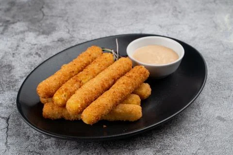 Stack of deep fried mozzarella cheese sticks with hot melted cheese inside, s Stock Photos
