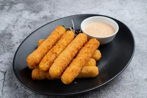 Stack of deep fried mozzarella cheese sticks with hot melted cheese inside, s Stock Photos