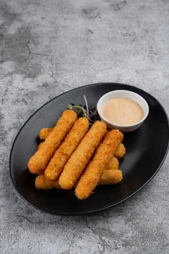Stack of deep fried mozzarella cheese sticks with hot melted cheese inside, s Stock Photos