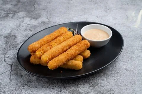 Stack of deep fried mozzarella cheese sticks with hot melted cheese inside, s Stock Photos