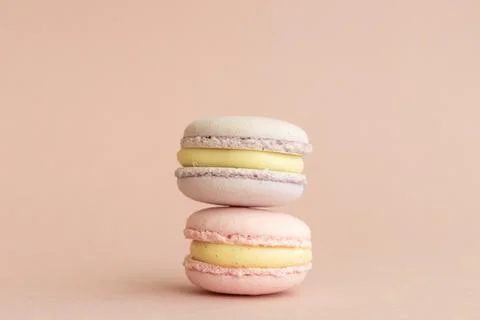 Stack of delicious almond macaroons on plain background, delicate dessert Stock Photos