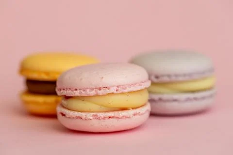 Stack of delicious almond macaroons on plain background, delicate dessert Stock Photos