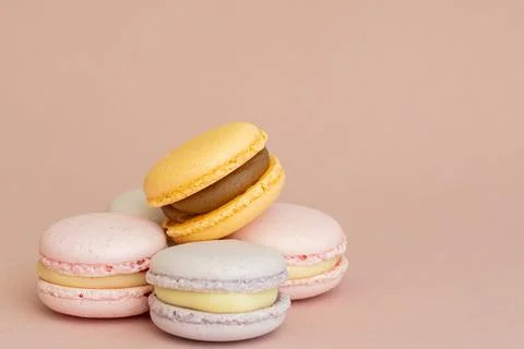 Stack of delicious almond macaroons on plain background, delicate dessert Stock Photos