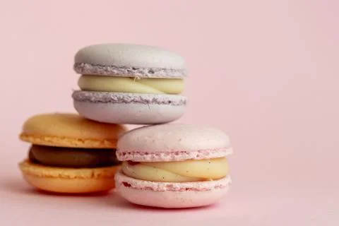 Stack of delicious almond macaroons on plain background, delicate dessert Stock Photos