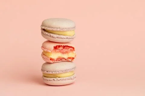 Stack of delicious almond macaroons on plain background, delicate dessert Stock Photos