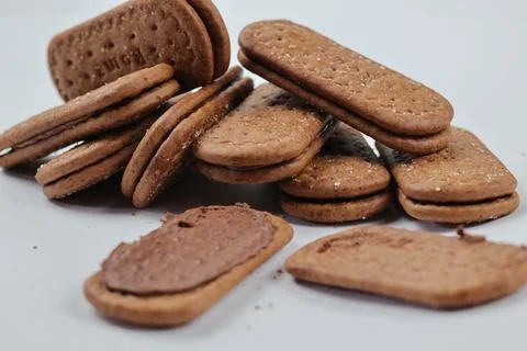 A stack of delicious brown wheat round biscuits with a few crumbs Stock Photos