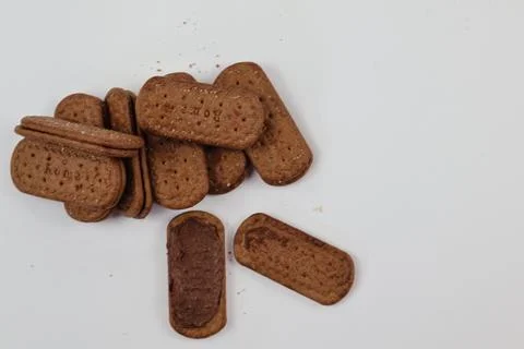 A stack of delicious brown wheat round biscuits with a few crumbs Stock-Fotos