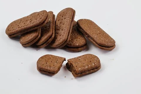 A stack of delicious brown wheat round biscuits with a few crumbs Foto stock